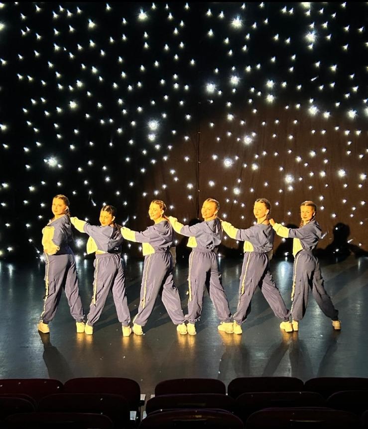 Solo ballet dancer on stage performing elegant movement